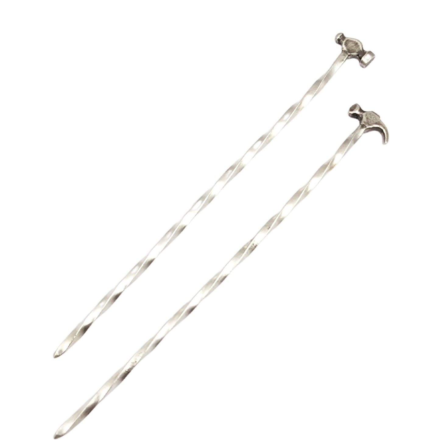 Sterling silver cocktail pick. One pick has a small ball peen hammer at the top, the other has a small claw hammer. Wire portion of the pick is twisted.