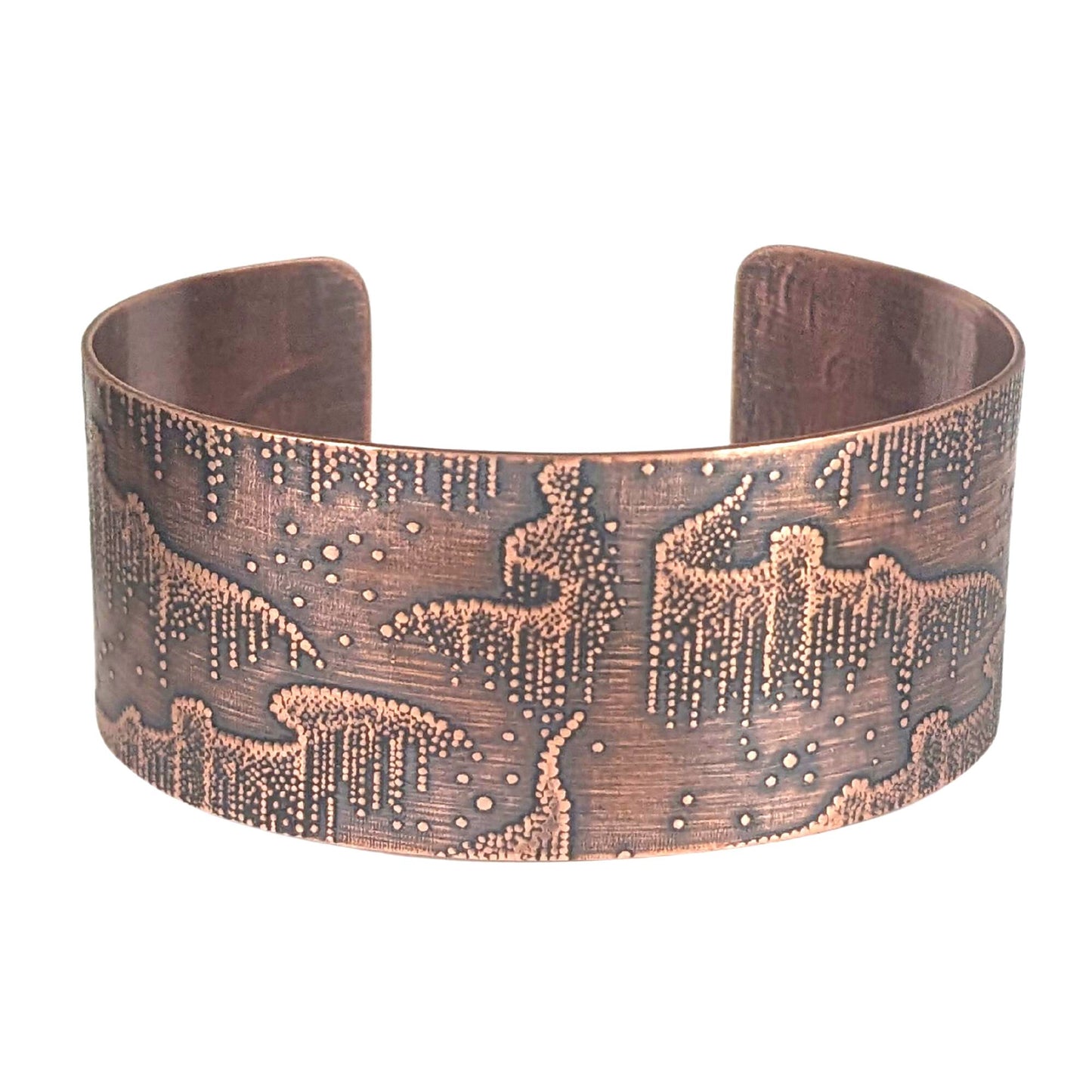 Wide copper cuff bracelet with repeated design pattern representing the aurora borealis