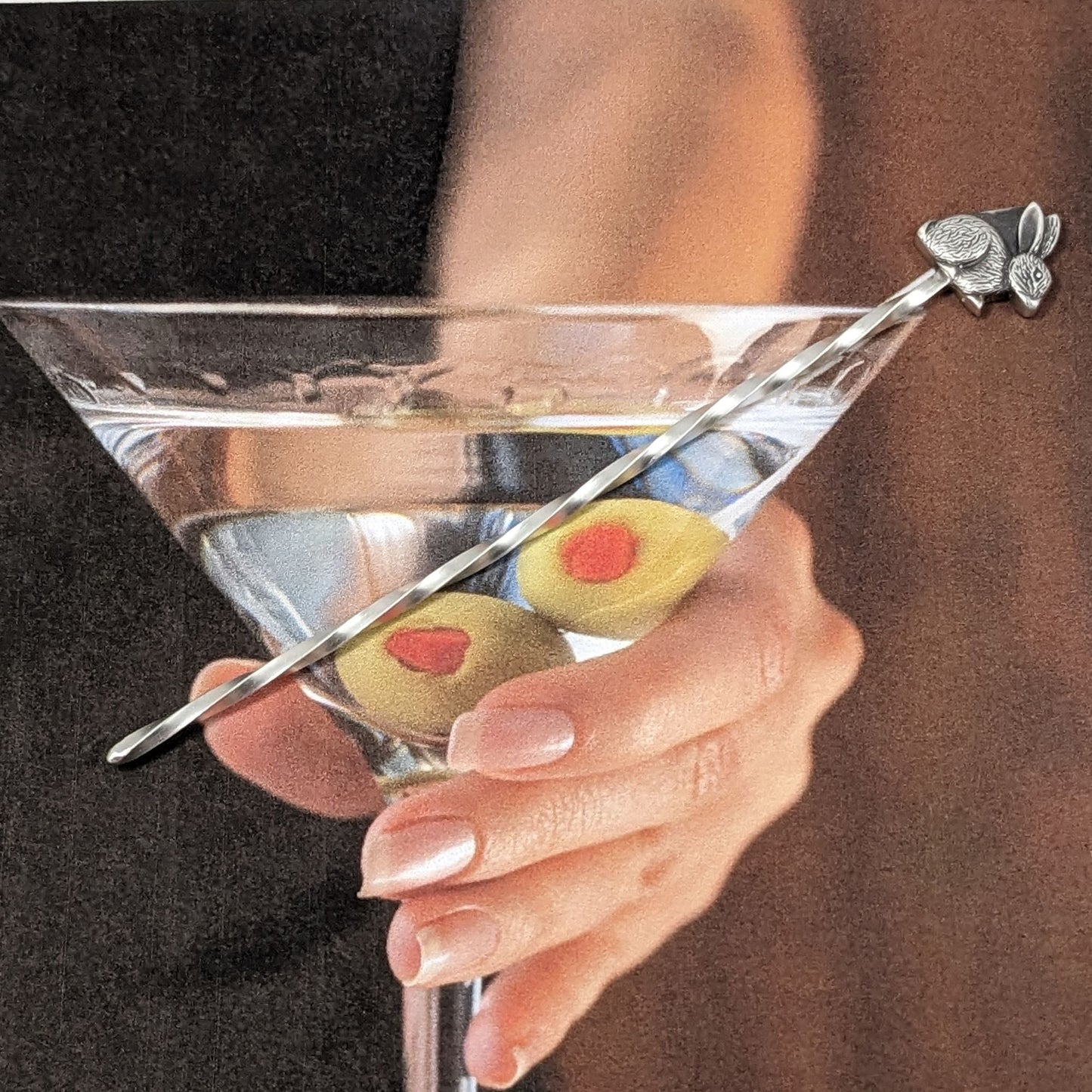 Sterling silver cocktail pick with silver rabbit on top.