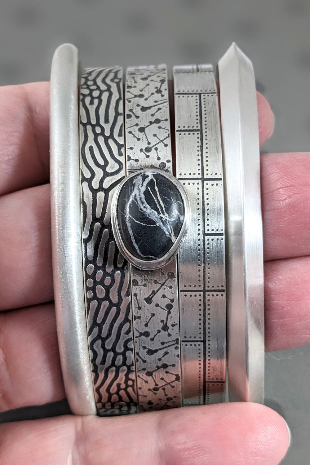 Collection of 5 sterling silver cuff bracelets in a men's size.