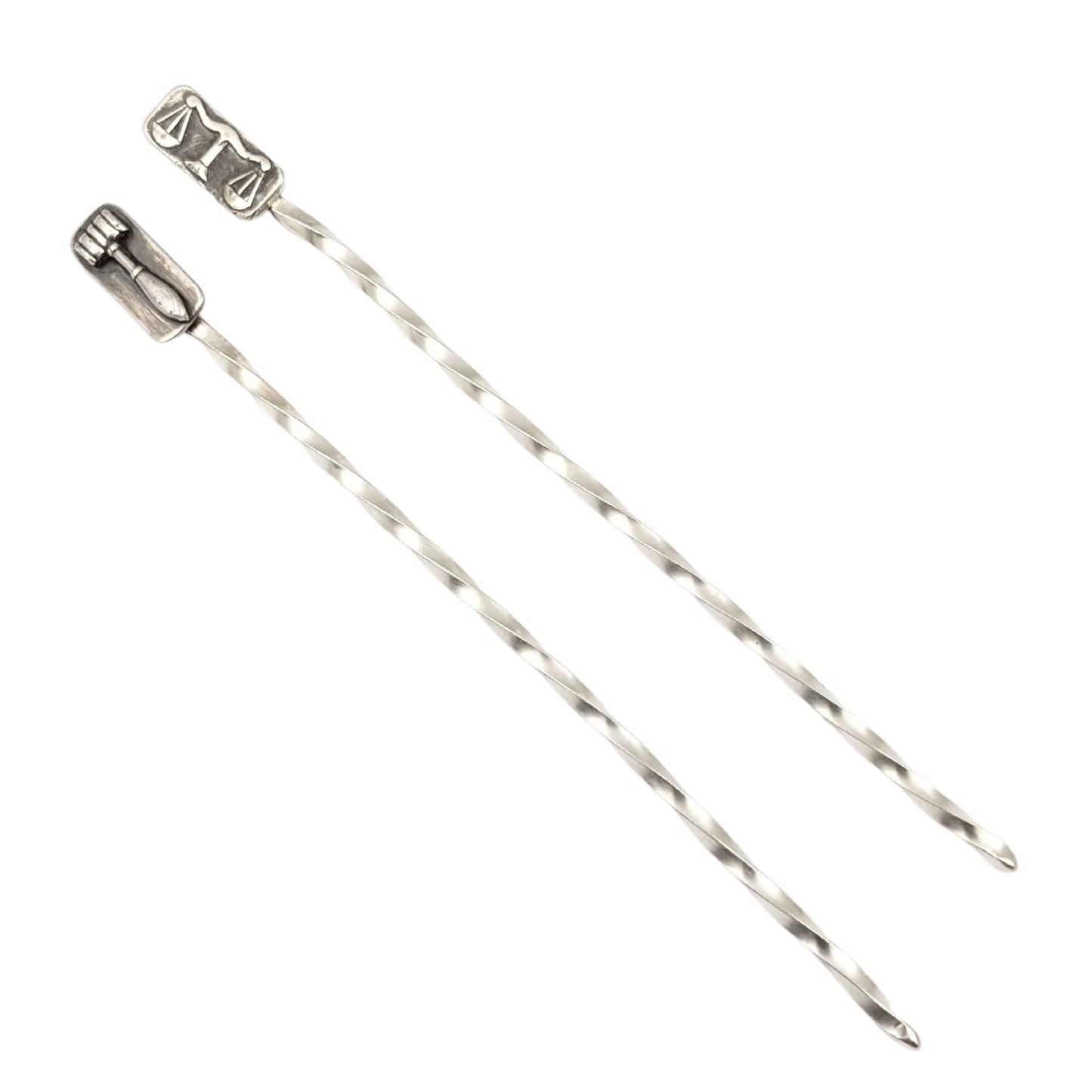 Sterling silver cocktail pick. One pick has the scales of justice at the top, the other has a gavel. Wire portion of the pick is twisted.