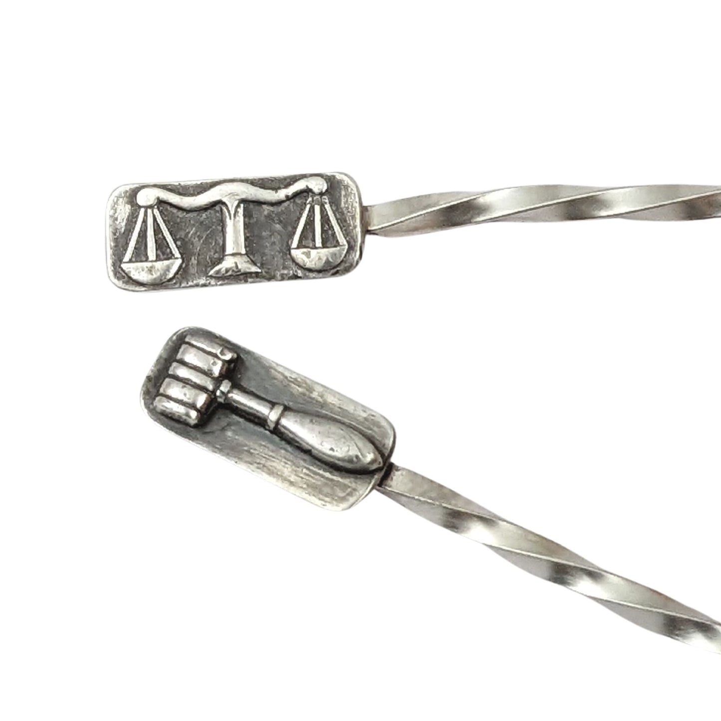 Sterling silver cocktail pick. One pick has the scales of justice at the top, the other has a gavel. Wire portion of the pick is twisted.