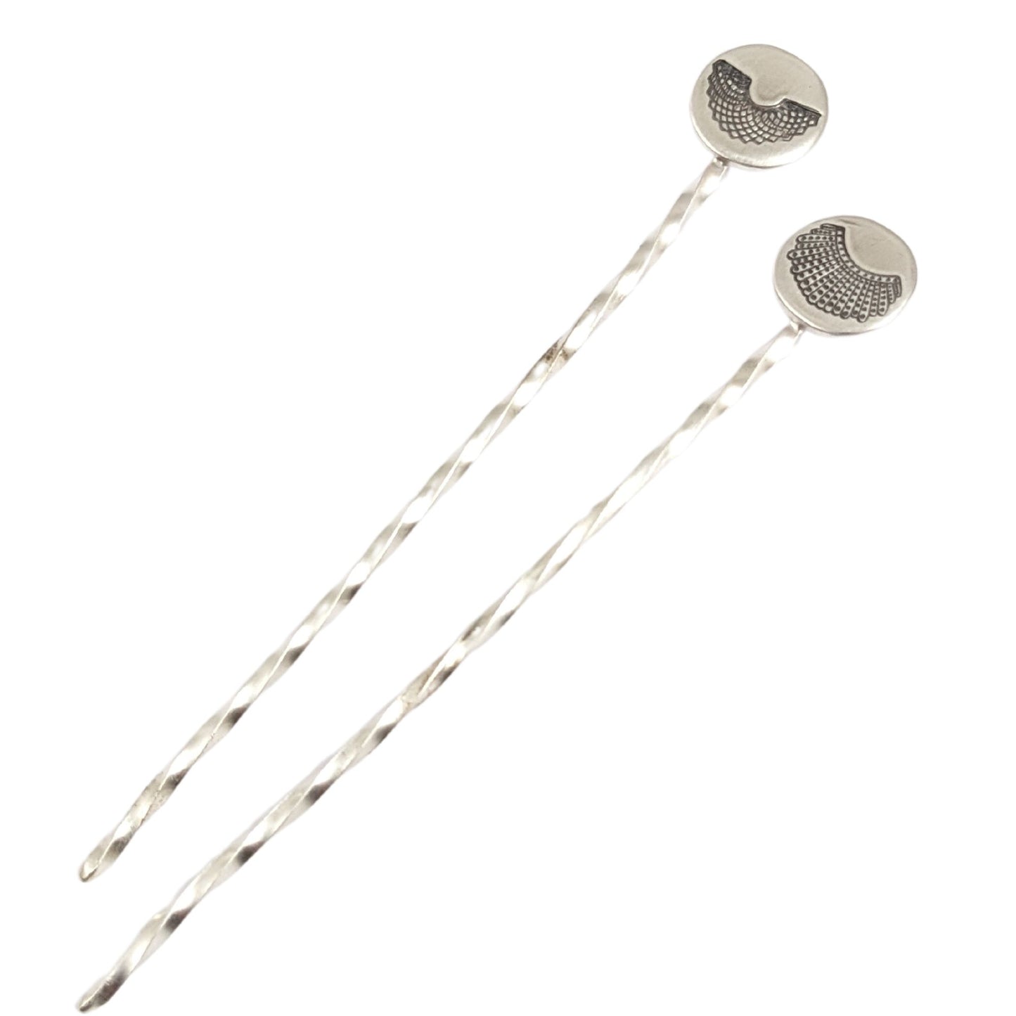 Sterling silver cocktail pick with decorative element on top. One has a round disc with stamping of RBGs Favorite collar, the other of RGB's Dissent Collar