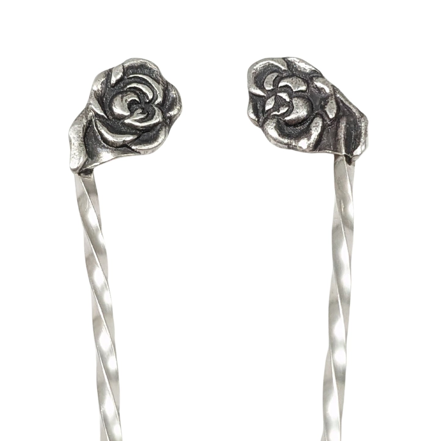 Pair of sterling silver cocktail picks, each with a rose on top.