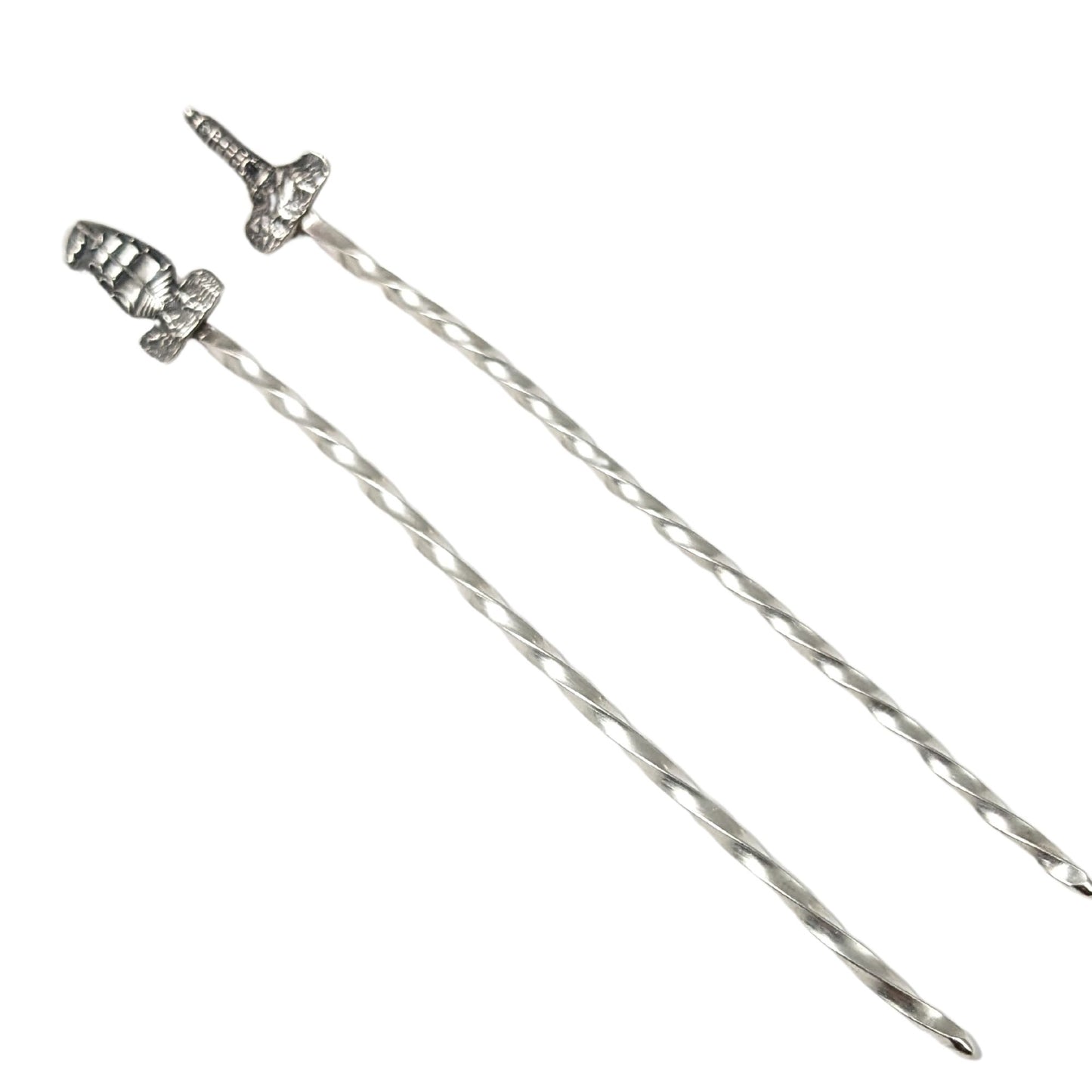 Pair of sterling silver cocktail picks. One has a lighthouse on top, the other has a tall ship.