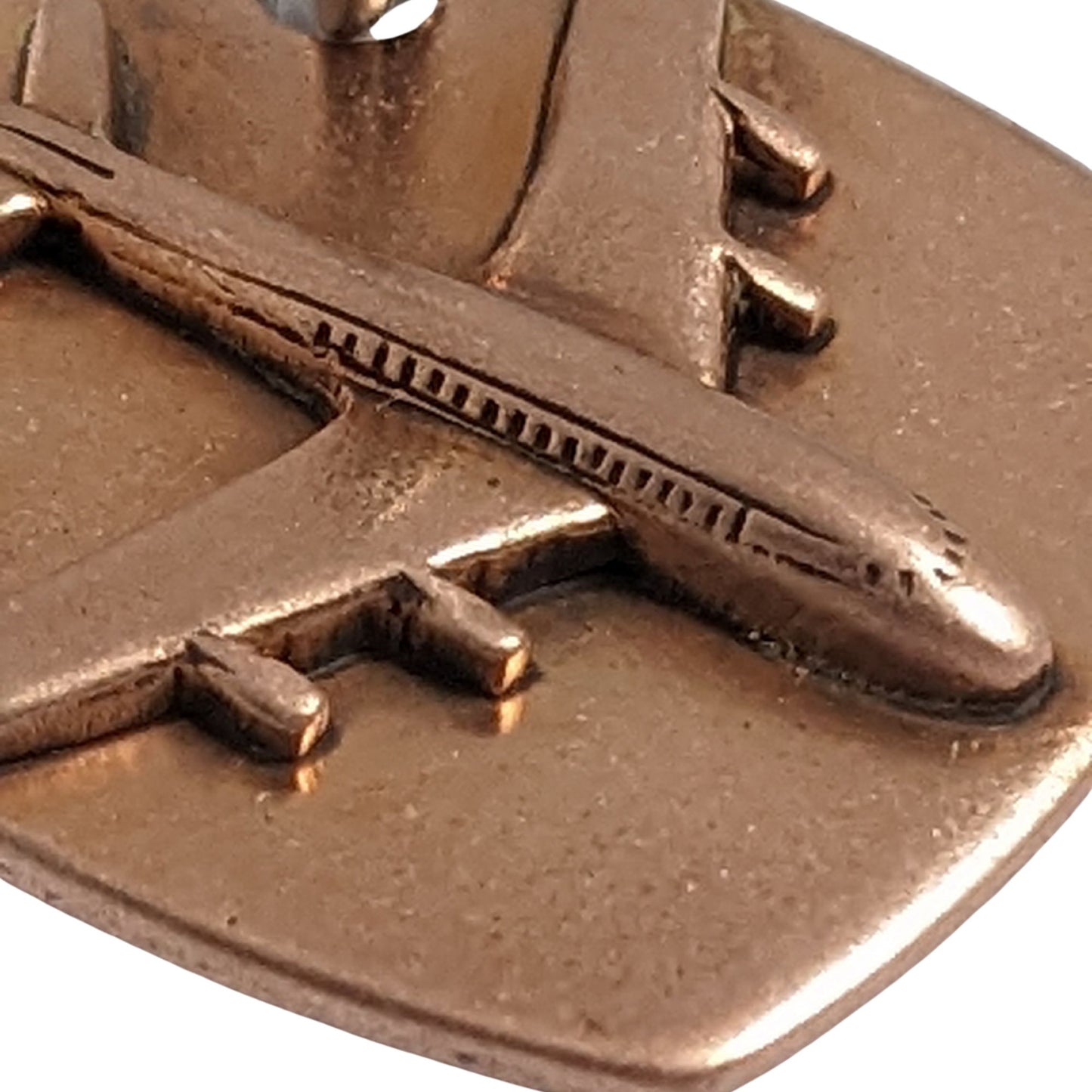 copper keychain with three dimensional passenger airplane