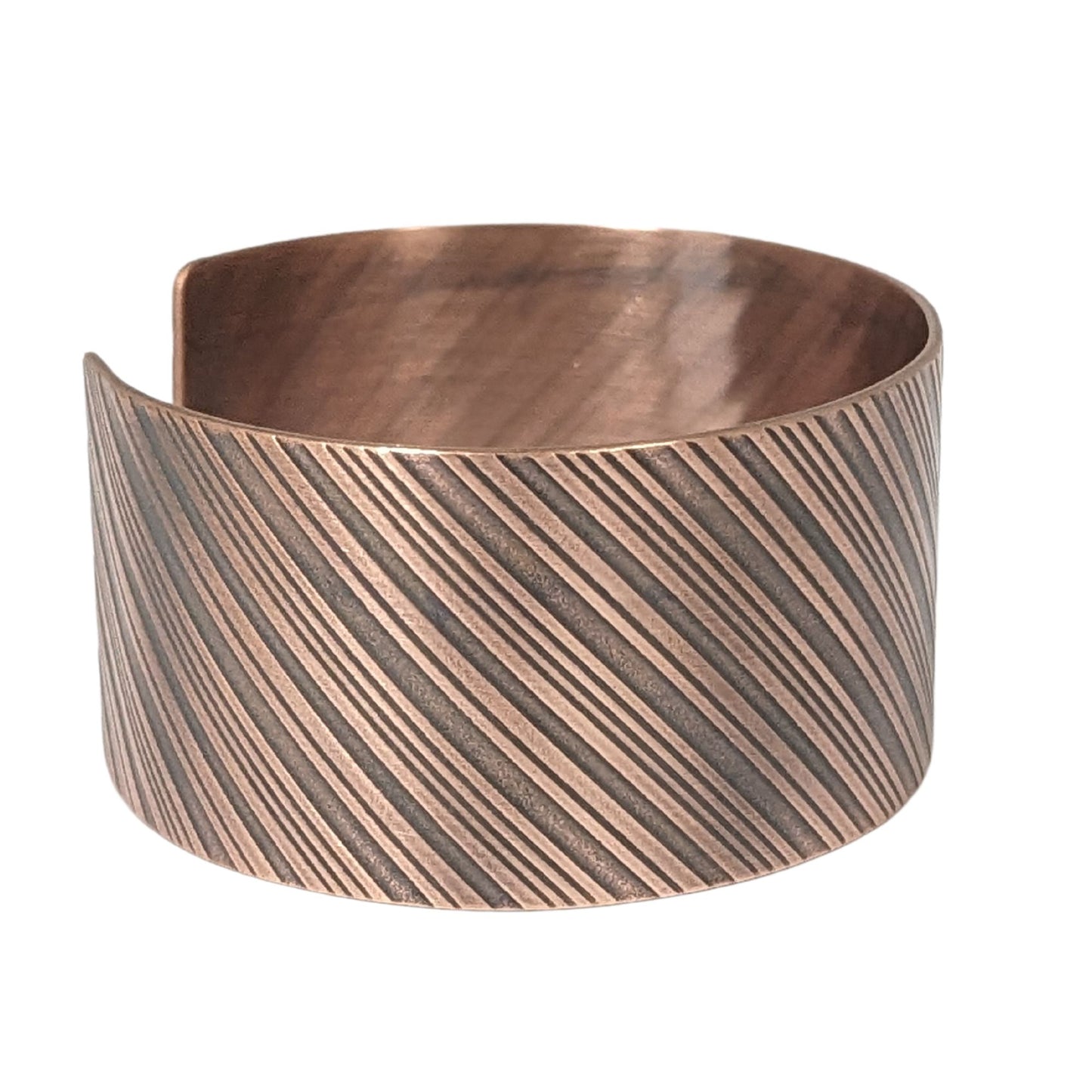 copper cuff bracelet with diagonal stripes like found on candy canes