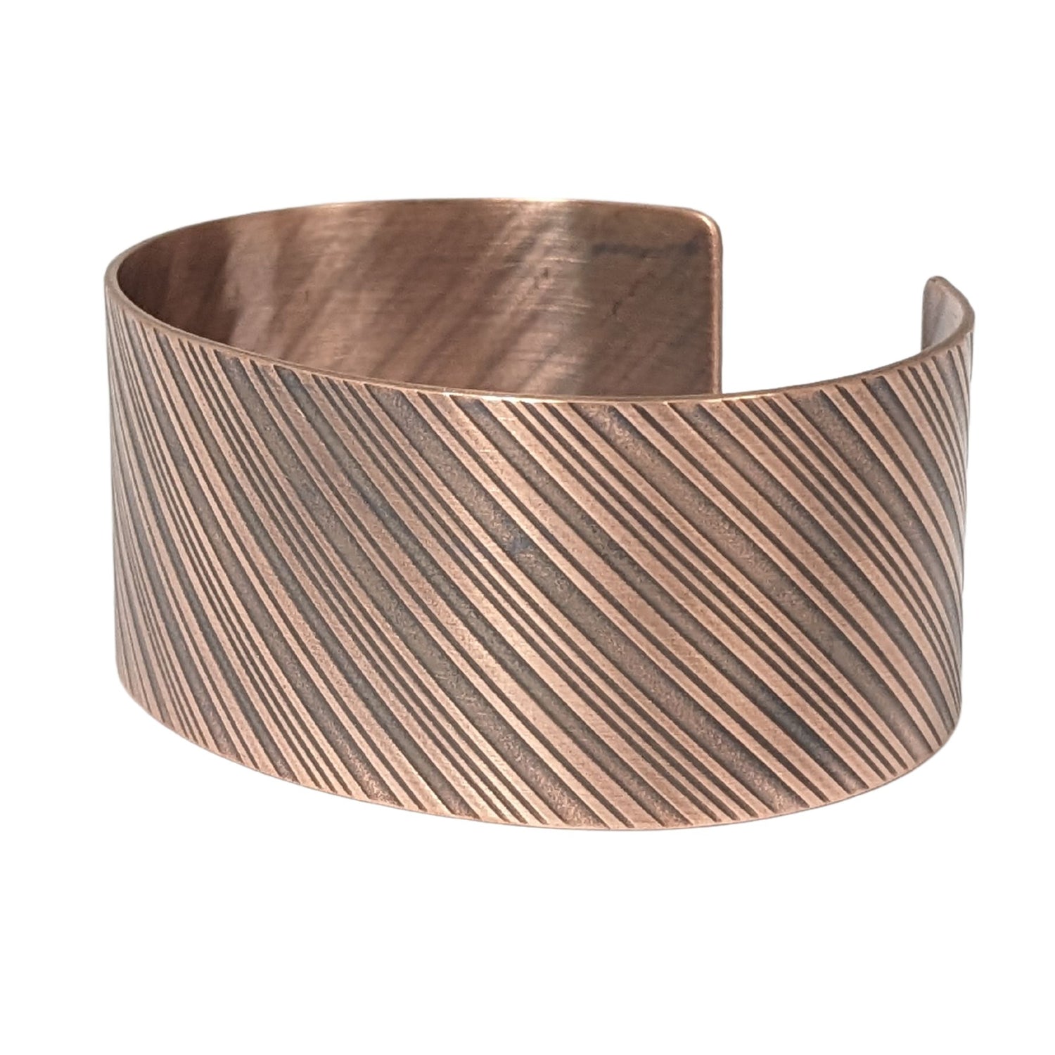copper cuff bracelet with diagonal stripes like found on candy canes