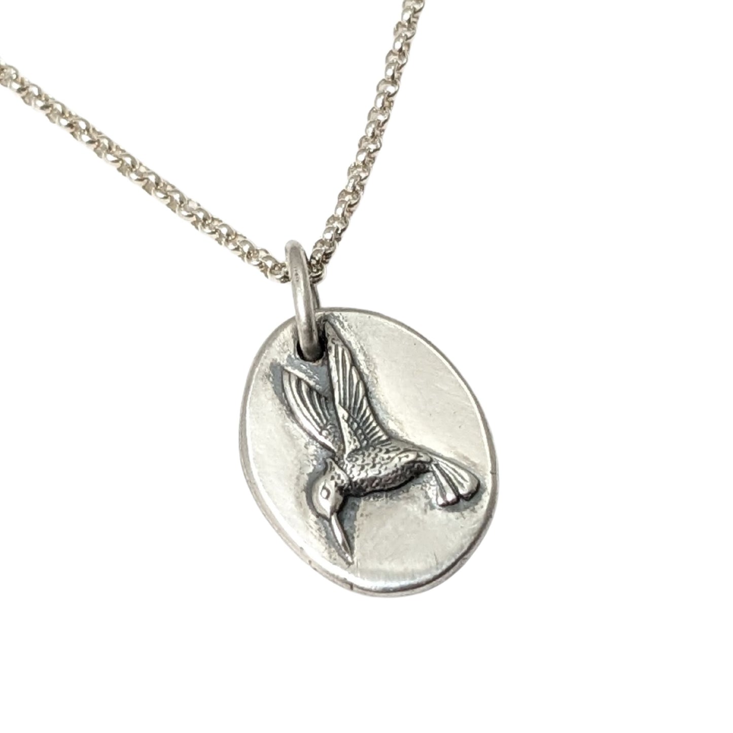 Sterling silver pendant with a three dimensional hummingbird design.