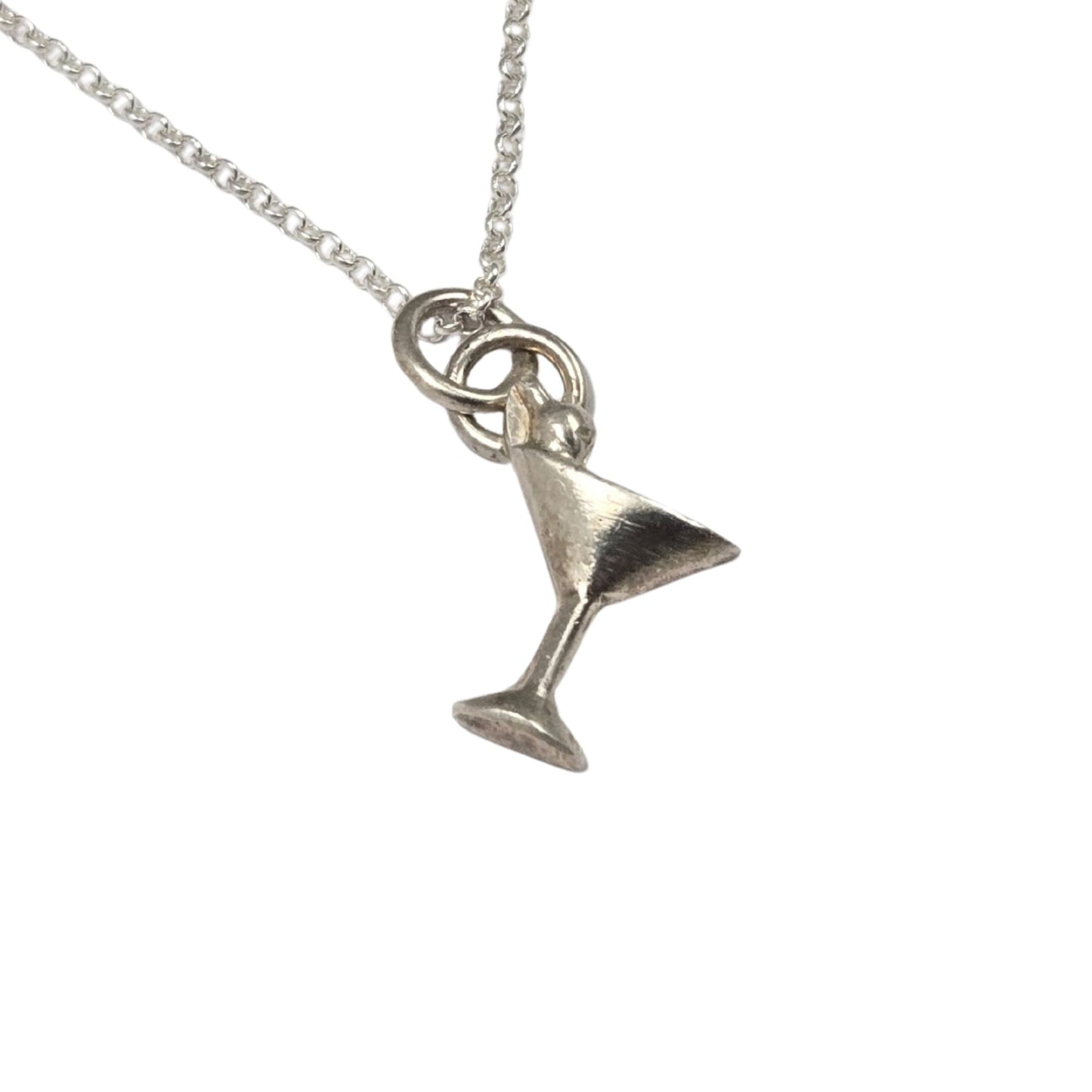 Silver martini glass pendant on a chain against a white background