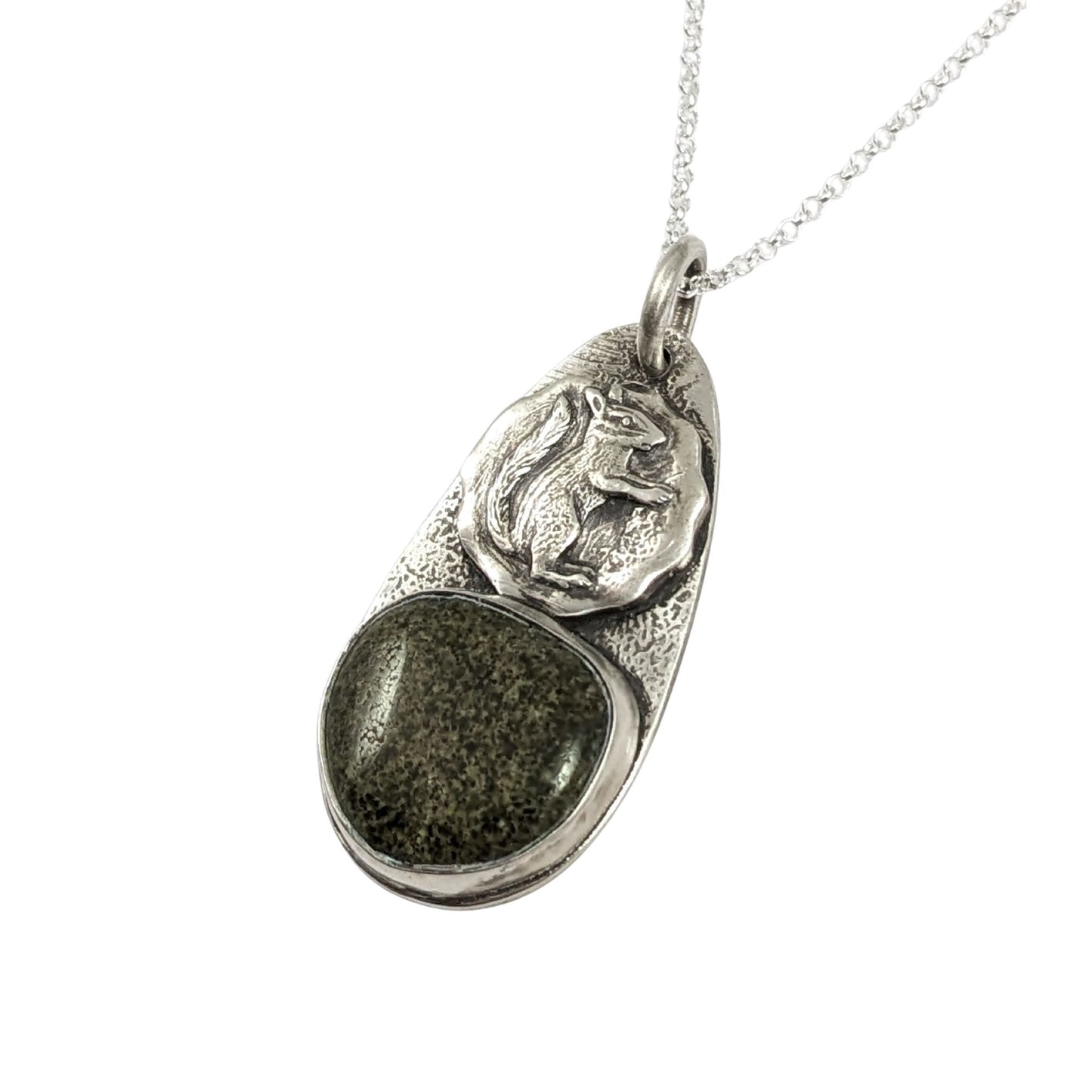 Oval sterling silver pendant. The top half has a circle with a raised image of a squirrel, the bottom half is a speckled green and tan stone.