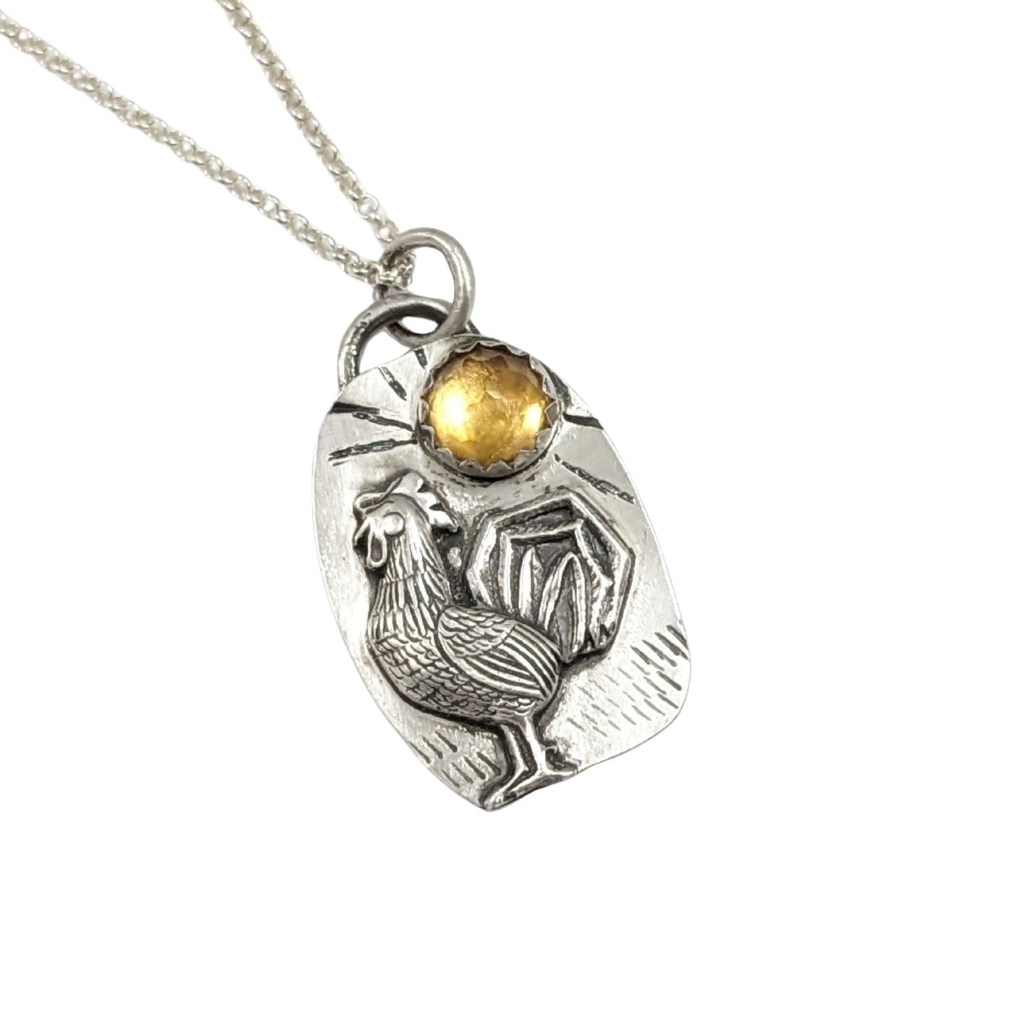 Sterling silver pendant with a three dimensional rooster and a yellow citrine gemstone on a textured background