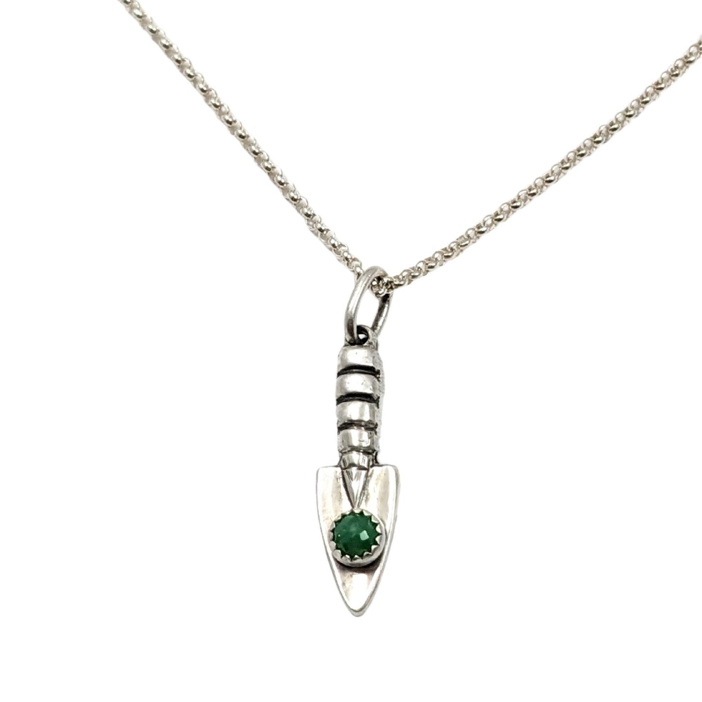 Three dimensional sterling silver garden hand trowel pendant with a faceted green chrysoprase gemstone on the trowel handle.