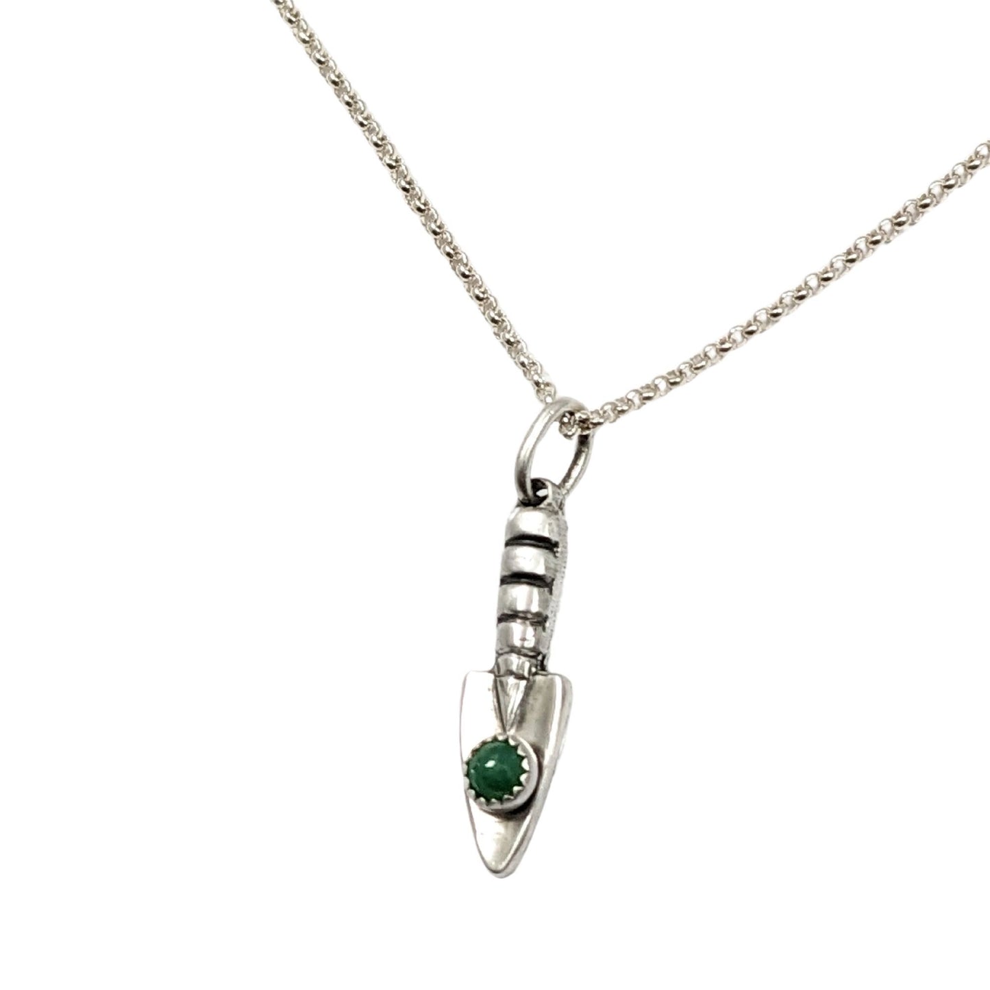Three dimensional sterling silver garden hand trowel pendant with a faceted green chrysoprase gemstone on the trowel handle.
