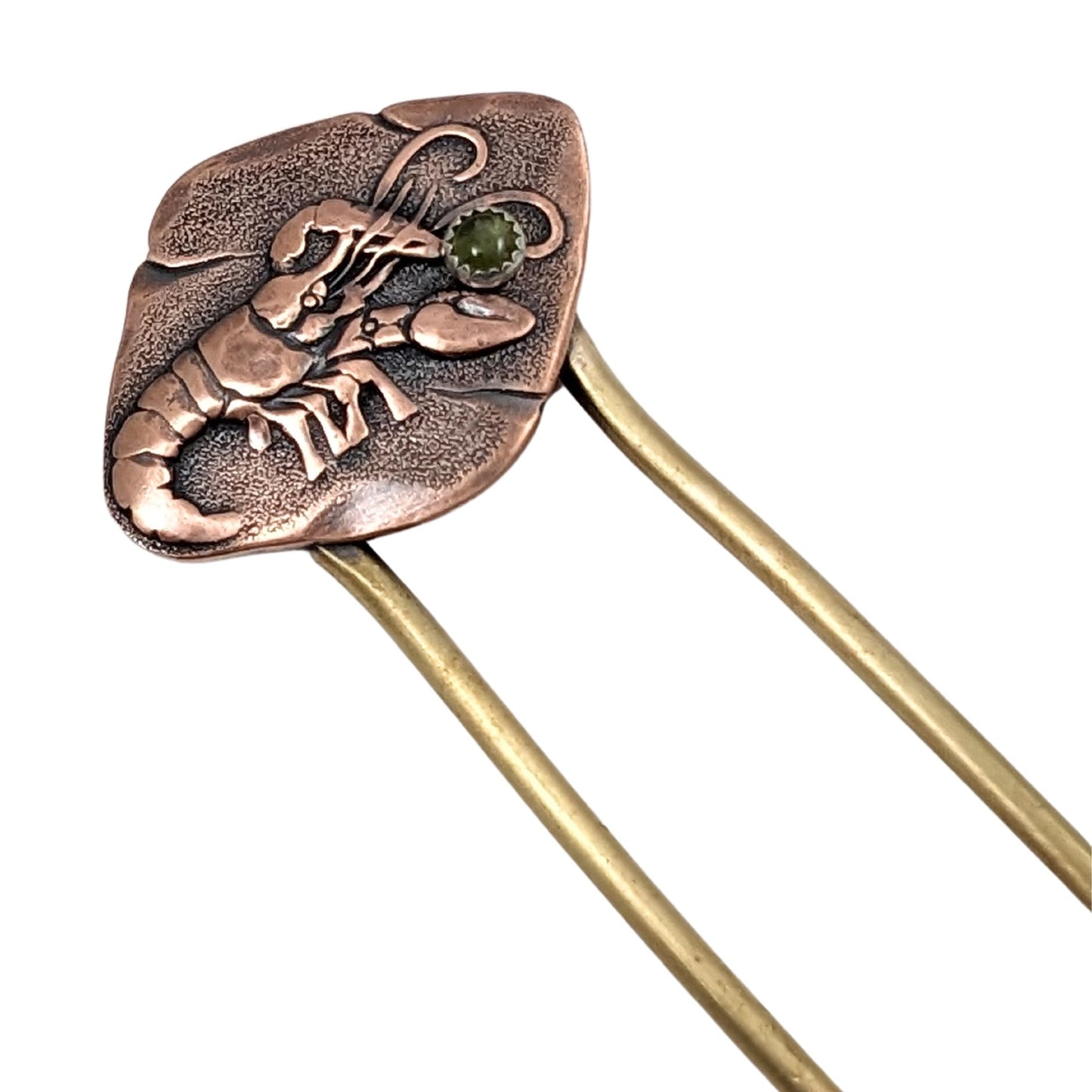 Lobster hair fork. The lobster design is an impression on a rectangular shaped piece of copper. There is a green tourmaline gemstone between the front claws.The fork is brass.
