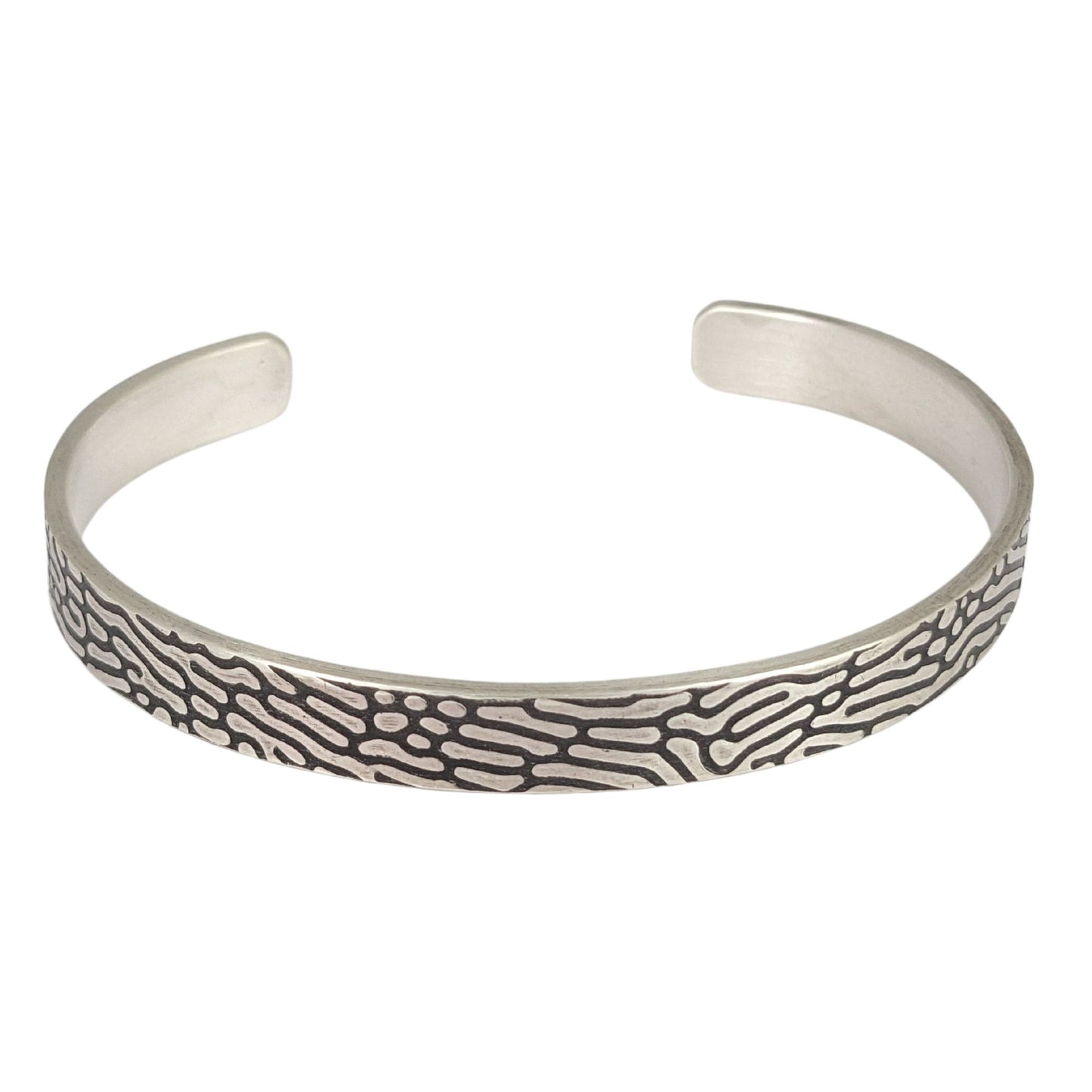 Rectangular shaped sterling silver wire cuff bracelet with an impressed design that looks like Brain Coral. The impressed design is darkened, so the coral lines are black against the silver.