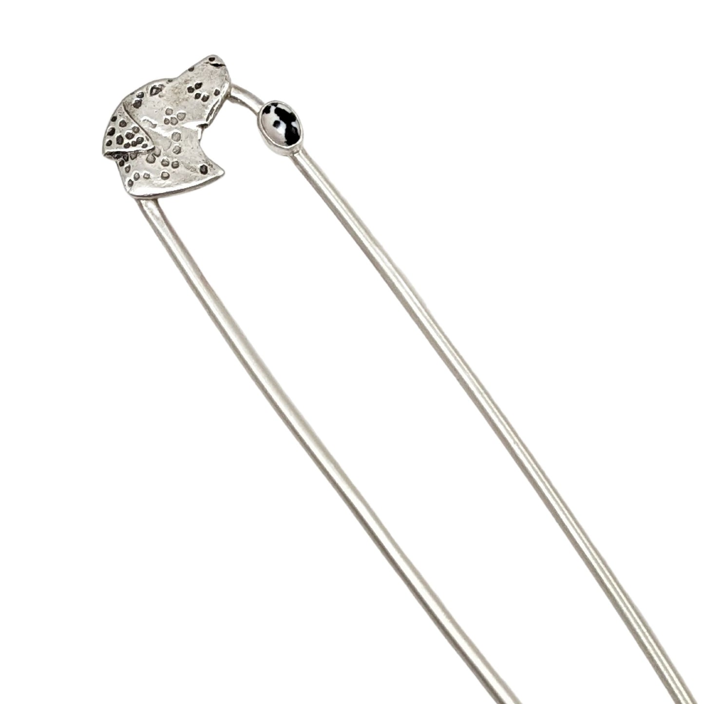 Sterling silver hair fork. Design is a profile of a dalmatian dog head and neck. There is a small oval black and white stone near the top of the right fork. The dalmatian spots are darkened.
