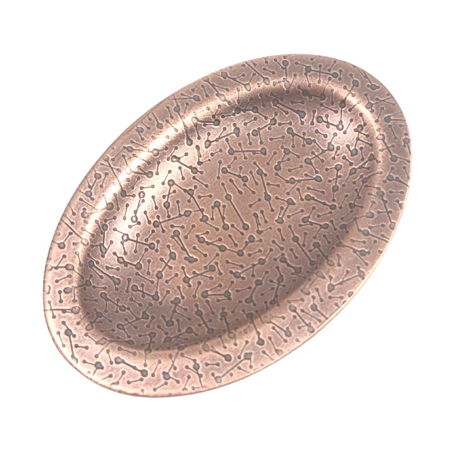 Oval ring dish made of copper. The dish has a shallow bowl with a lip around the edge. It is covered in a pattern meant to represent a meteor shower. The pattern is impressed into the copper and is short lines with small solid circles at the end. The design is oxidized, which means the impressed parts are dark, almost black.
