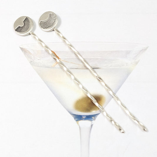 Sterling silver cocktail pick with decorative element on top. One has a round disc with stamping of RBGs Favorite collar, the other of RGB's Dissent Collar