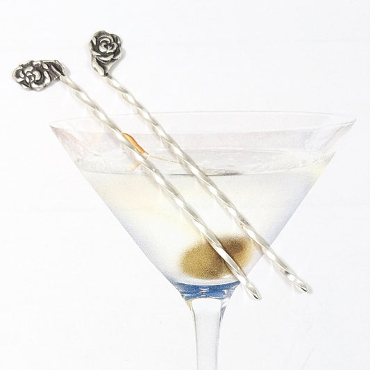 Pair of sterling silver cocktail picks, each with a rose on top.