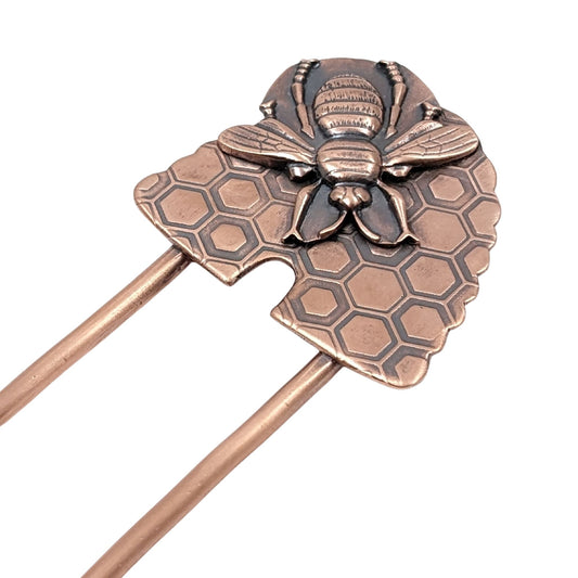 Copper Hair Fork with Bee and Beehive. The large beehive has a honeycomb design and the bee is very detailed and large enough to cover most of the hive. Recessed areas are darkened to highlight the details.