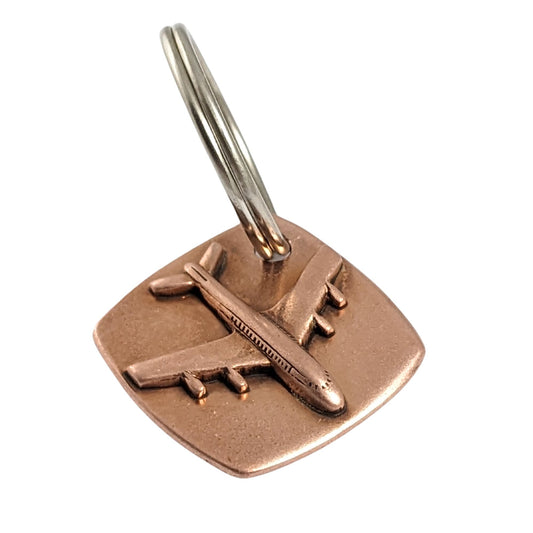 copper keychain with three dimensional passenger airplane