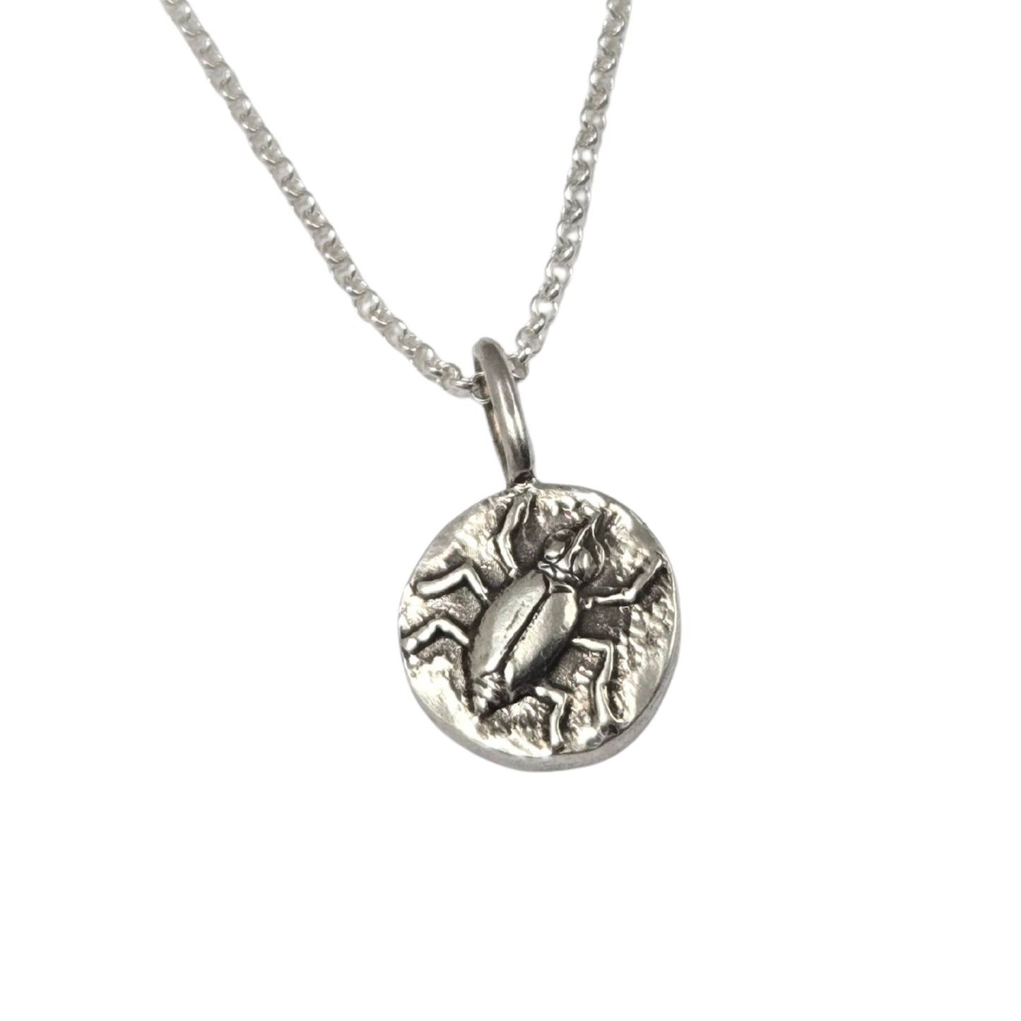 Round sterling silver pendant with beetle design