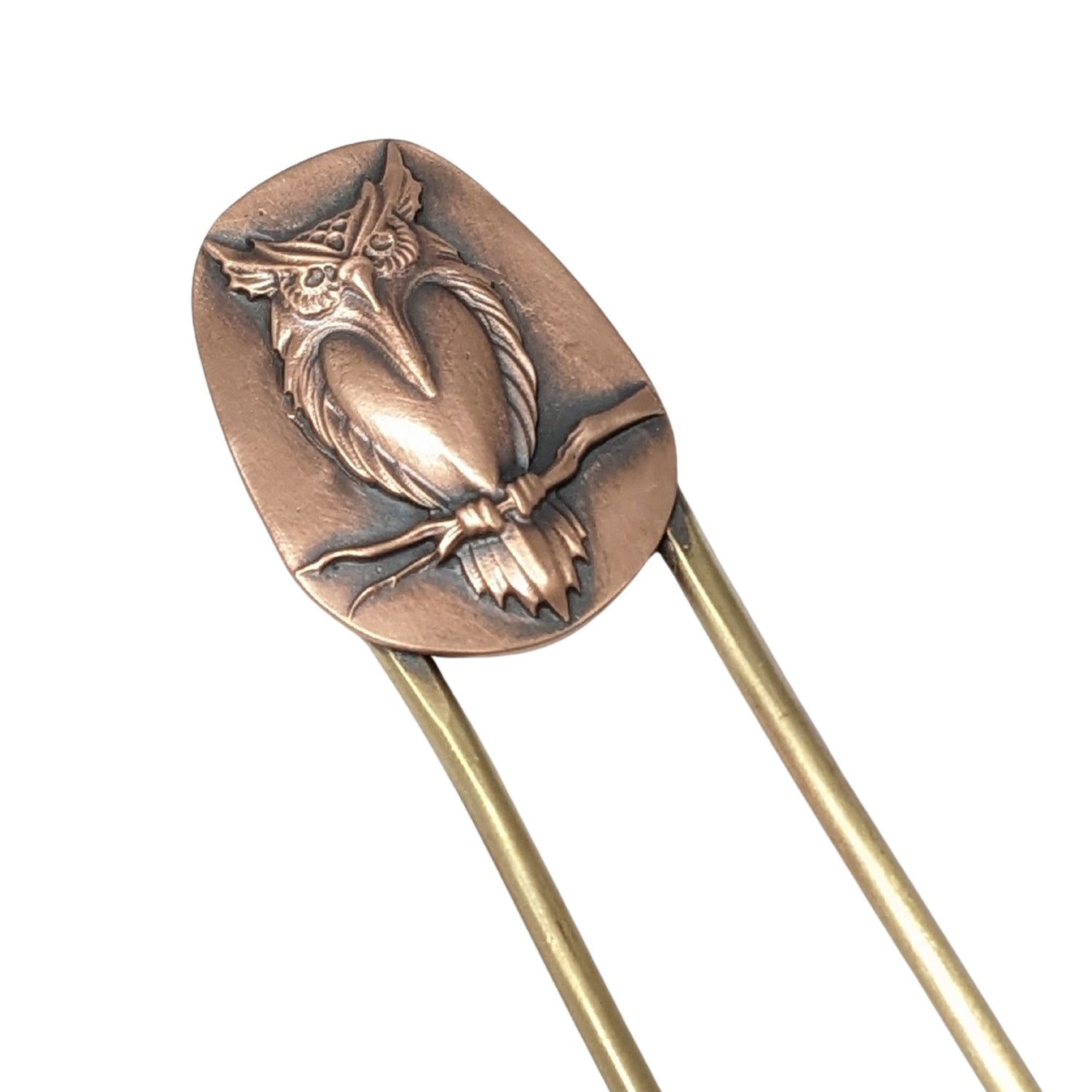 Brass hair fork with copper design element at top. The copper has a raised image of an owl resting on a branch.