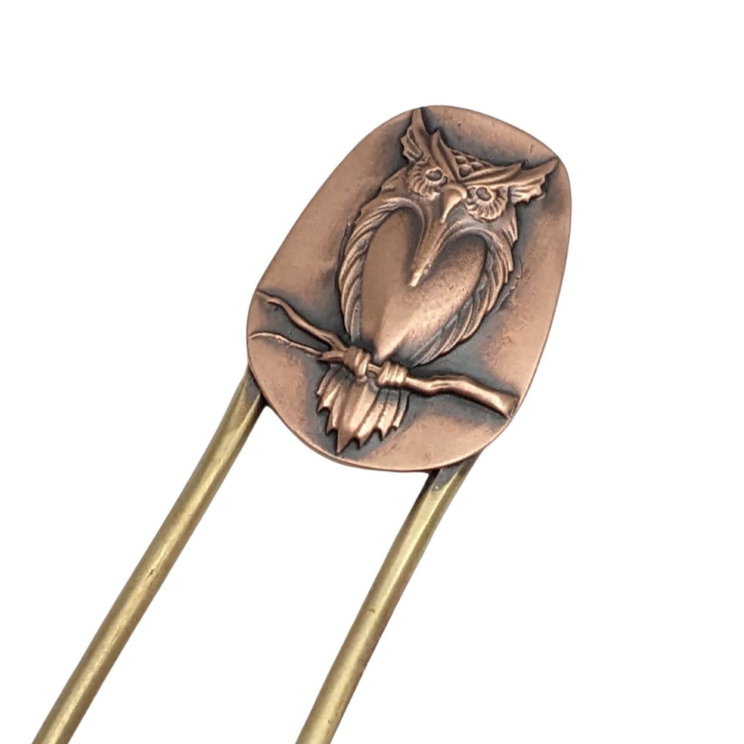 Brass hair fork with copper design element at top. The copper has a raised image of an owl resting on a branch.