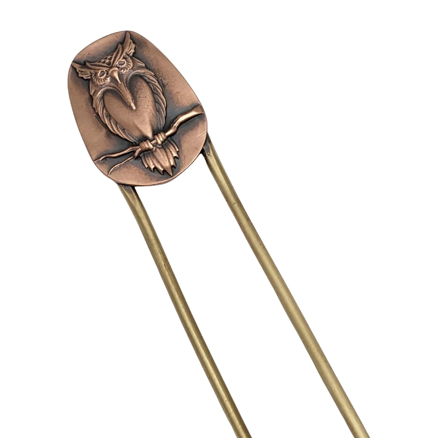 Brass hair fork with copper design element at top. The copper has a raised image of an owl resting on a branch.