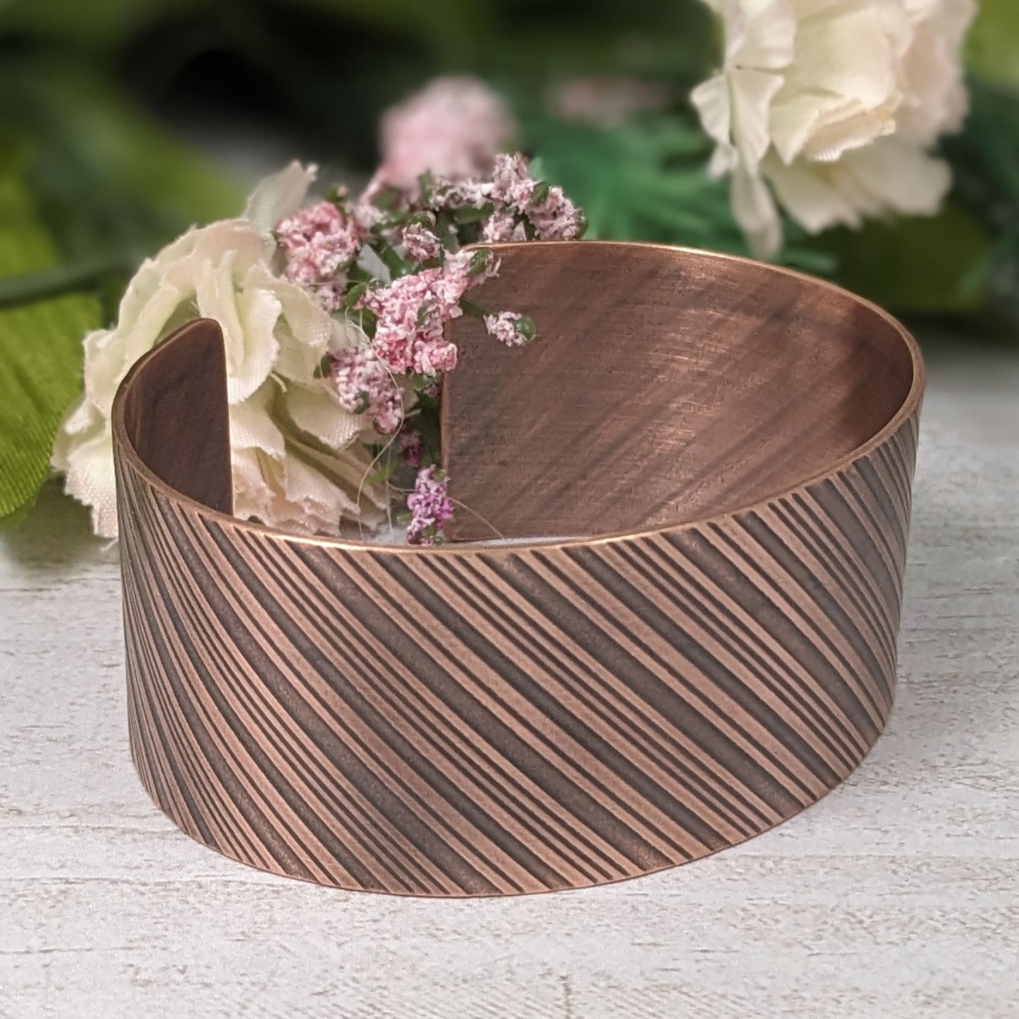 copper cuff bracelet with diagonal stripes like found on candy canes