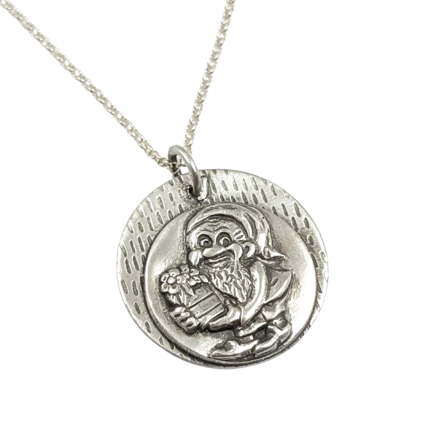 silver pendant with a garden gnome holding a barrel of produce