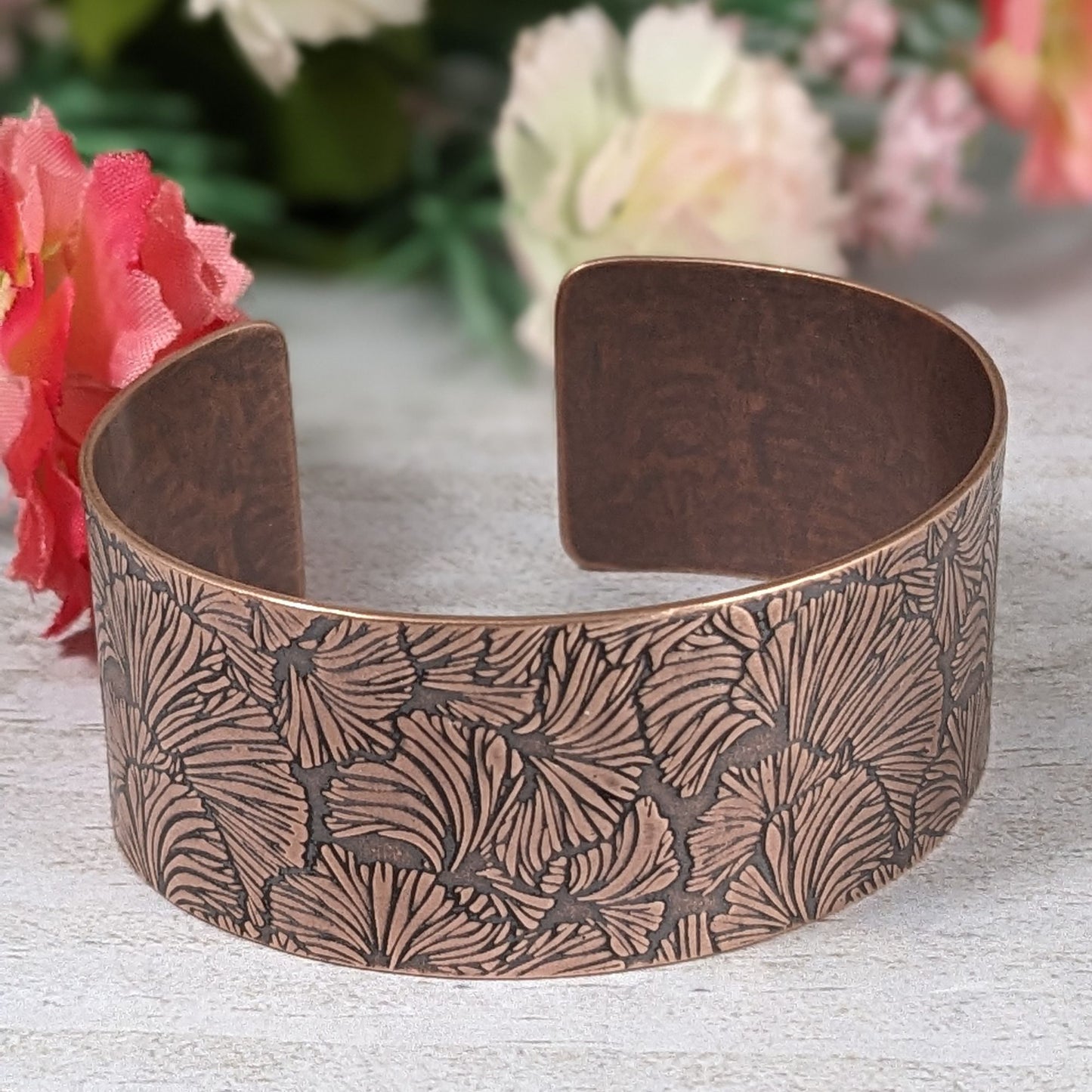 Copper cuff bracelet with a ginkgo leaf pattern design