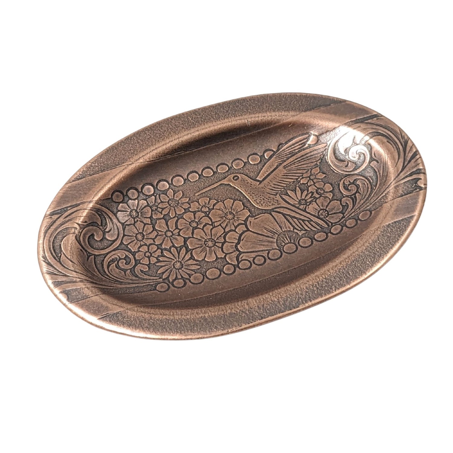 val copper ring dish with a raised lip. Pattern across middle is a hummingbird surronded by flowers. The edge of the pattern is a scrolled leaf resembling ferns.