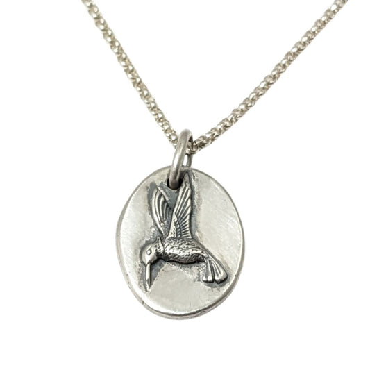 Sterling silver pendant with a three dimensional hummingbird design.