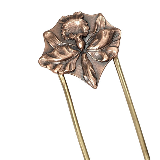 Large detailed iris in copper on a brass hair fork.
