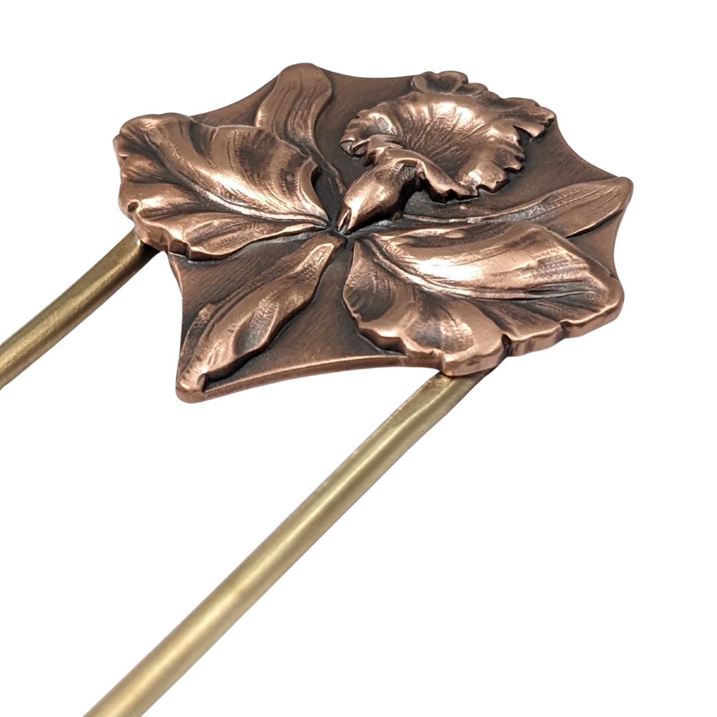 Large detailed iris in copper on a brass hair fork.