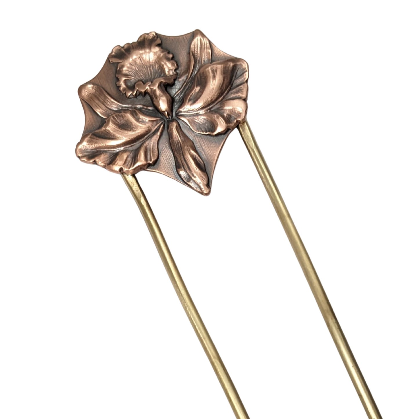Large detailed iris in copper on a brass hair fork.