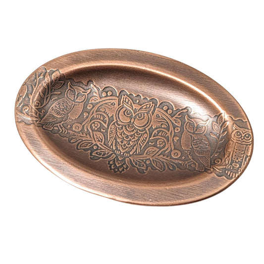 Oval copper ring dish with lip edge. Design across middle is one forward facing owl and one side facing owl on either side.