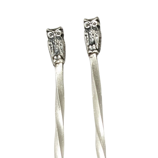 Sterling silver cocktail picks with small owl decoration at the top.