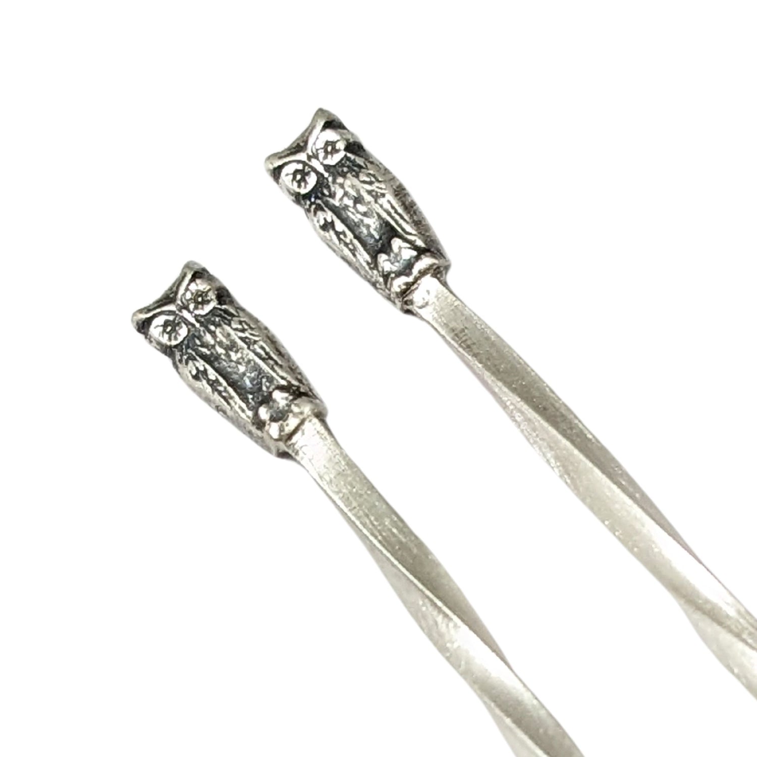 Sterling silver cocktail picks with small owl decoration at the top.