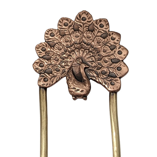 Copper hair fork of a peacock displaying it's plumage. Fork is brass.