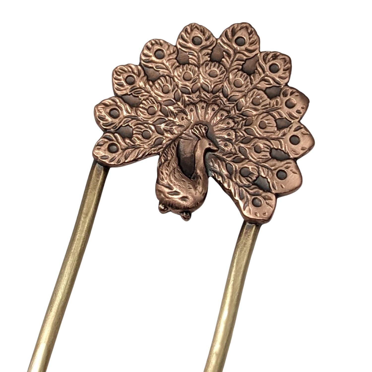 Copper hair fork of a peacock displaying it's plumage. Fork is brass.