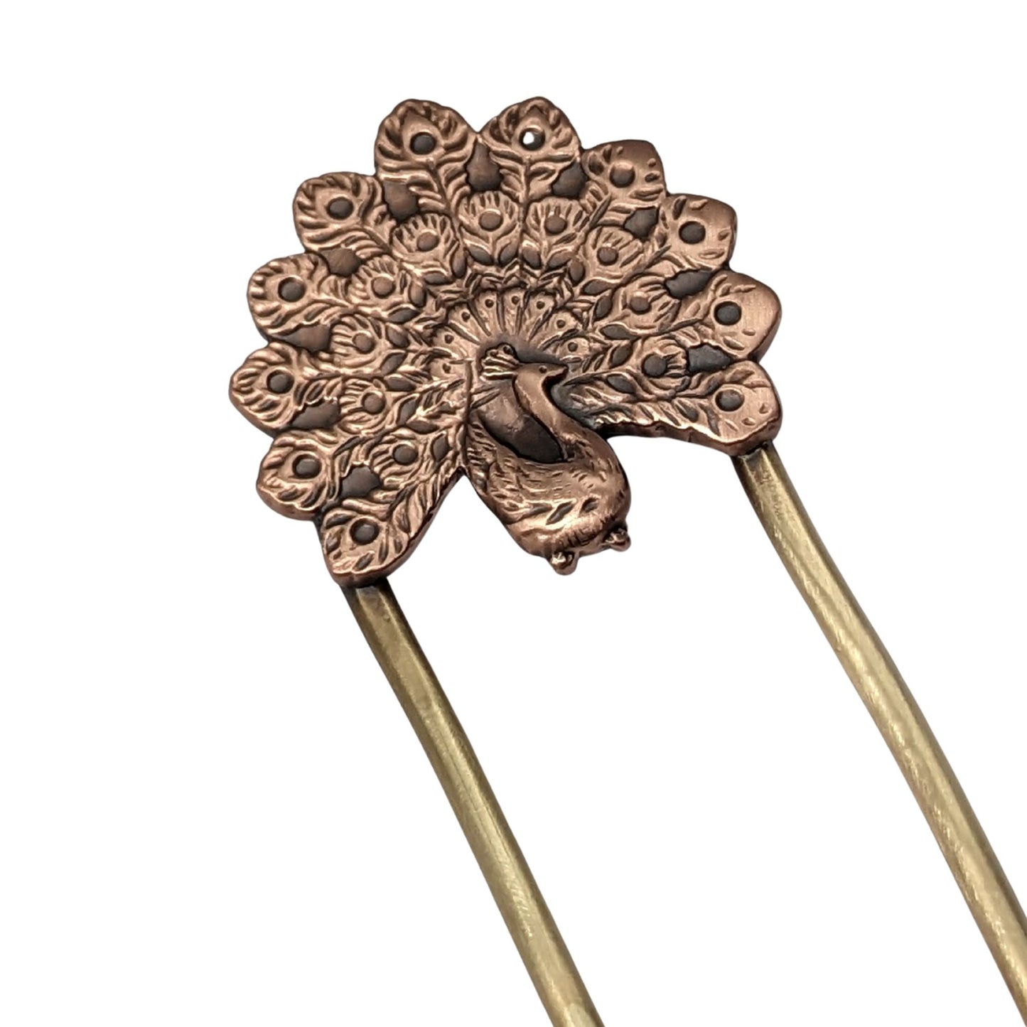 Copper hair fork of a peacock displaying it's plumage. Fork is brass.
