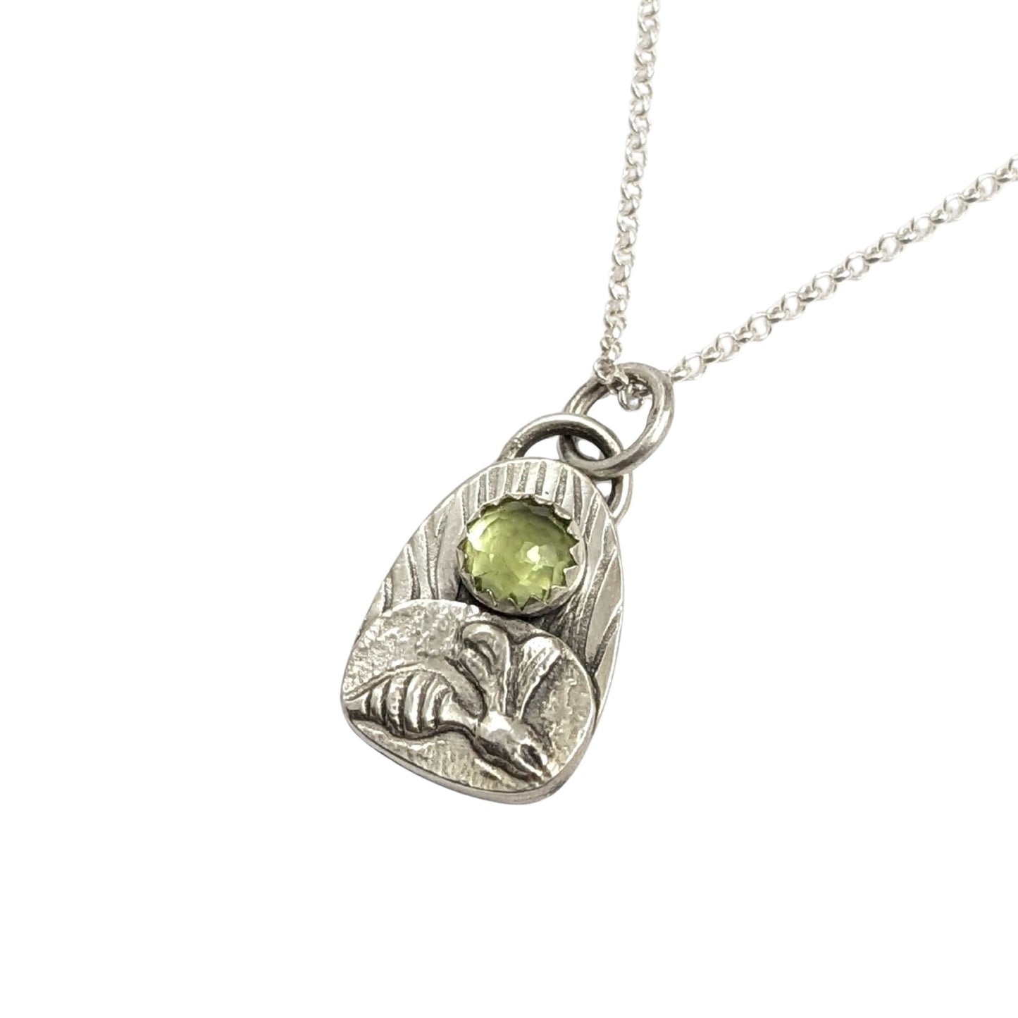 Wasp pendant from the set of four sterling silver pendants with pond creatures. each has a reed-textured background and green peridot gemstone. Creatures are wasp, lizard, frog, dragonfly.