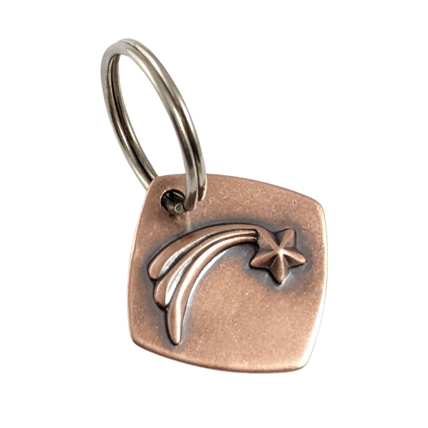 square copper keychain with raised shooting star and three tails