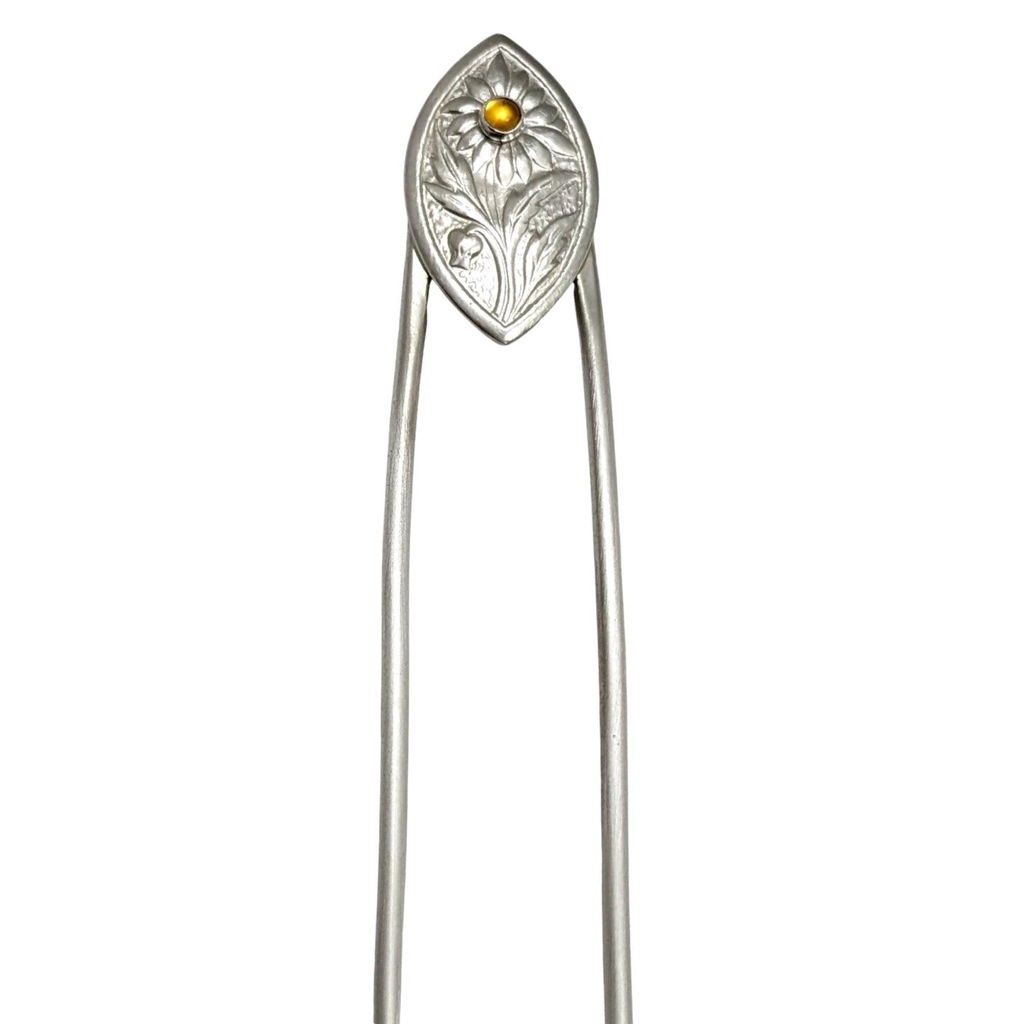 Sterling silver hair fork. The design at the top is a framed pointed oval with a sunflower plant scene. There is a yellow citrine gemstone in the middle of the sunflower.