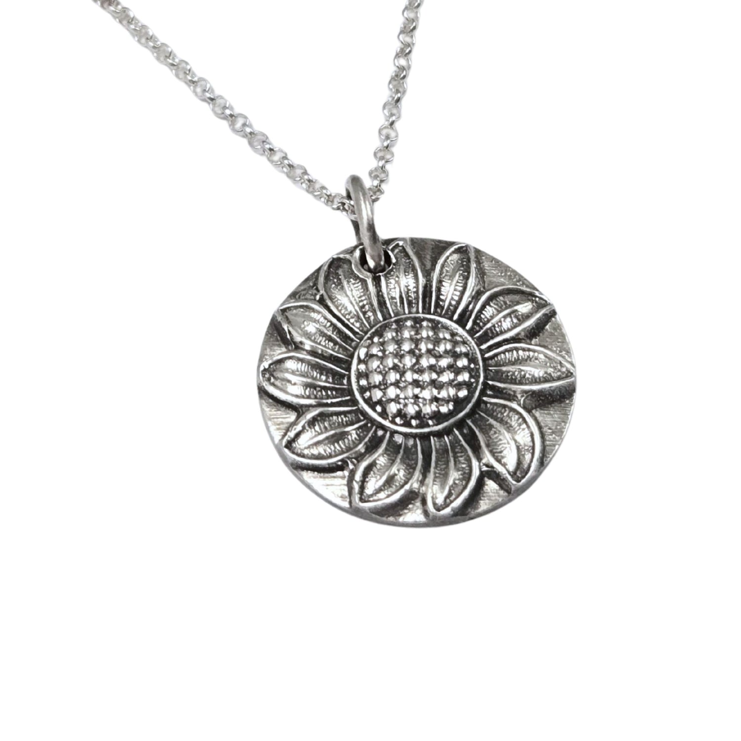 Silver sunflower pendant necklace on a white background