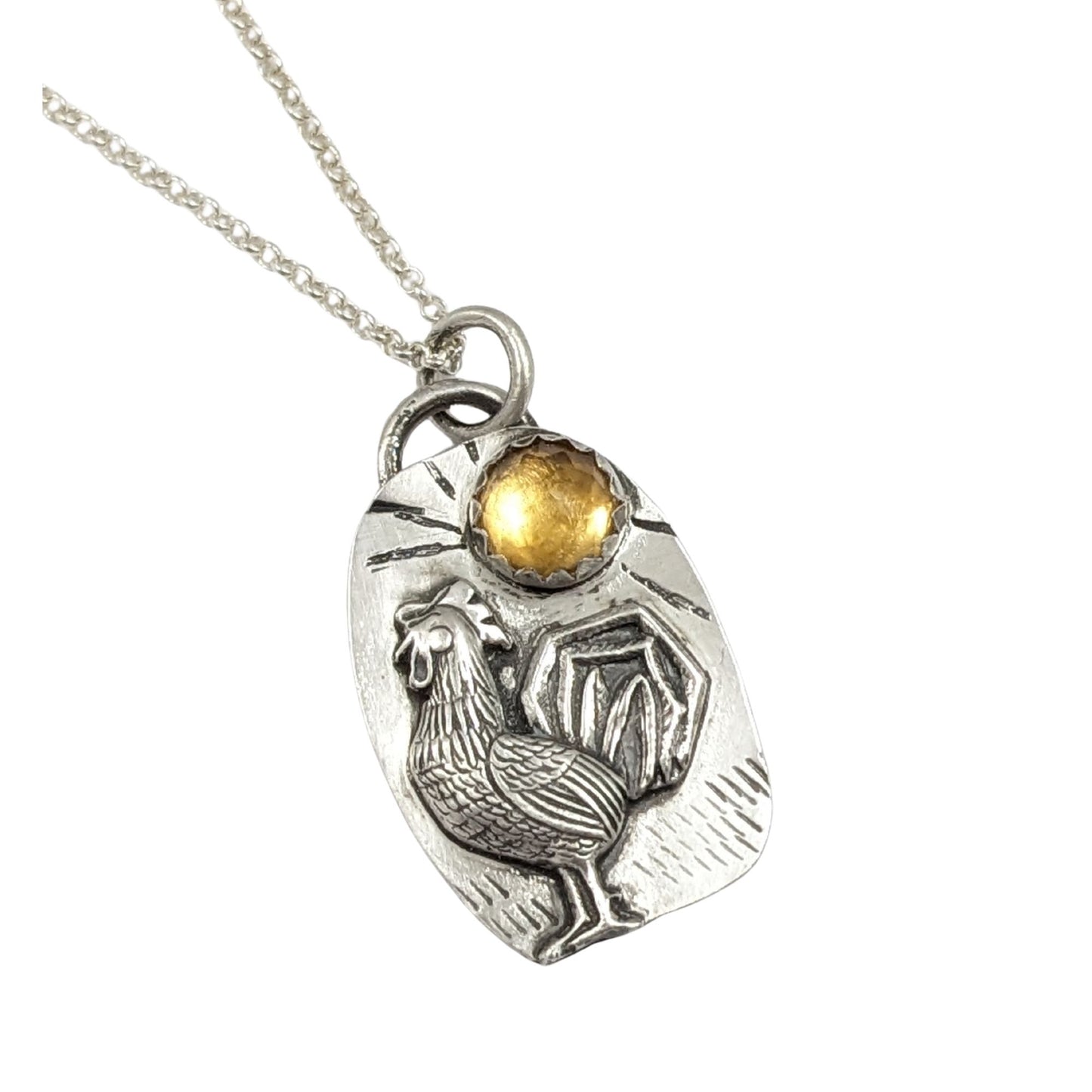 Sterling silver pendant with a three dimensional rooster and a yellow citrine gemstone on a textured background