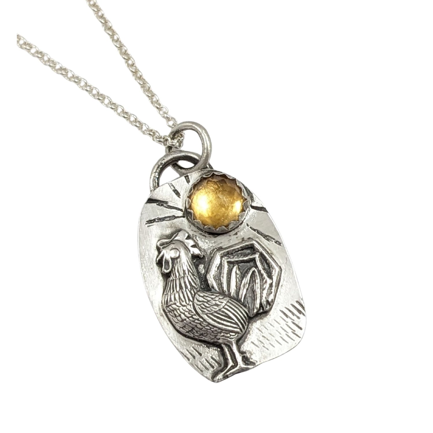 Sterling silver pendant with a three dimensional rooster and a yellow citrine gemstone on a textured background